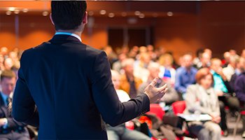 speaker in front of a seminar of learners