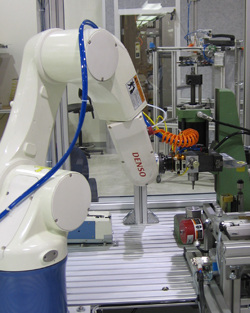 DENSO VS-Series six-axis articulated robot assembles flashlight components