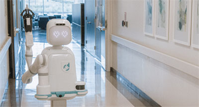 Moxi robot in a medical building hallway. Image source: Diligent Robots.