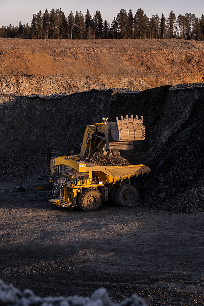 Shovel machine depositing ore into truck