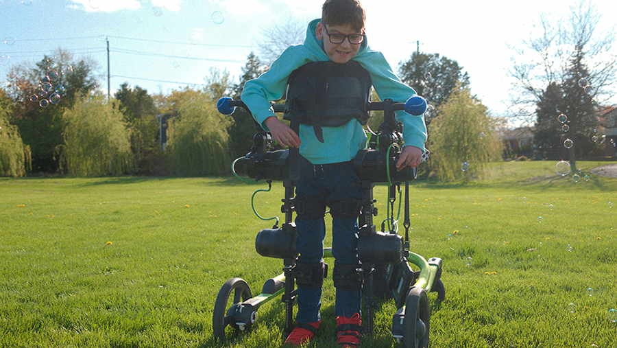 A child in an assistive mobility device.