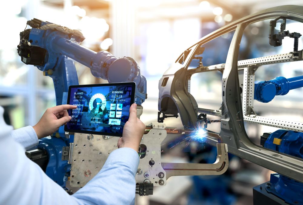 engineer using tablet controlling a robot
