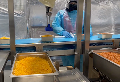 Chef robotics depositing cheese. Image courtesy of Chef Robotics.