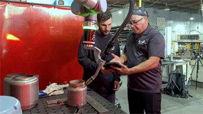  An experienced worker trains employee in welding process. Credit Universal Robots.