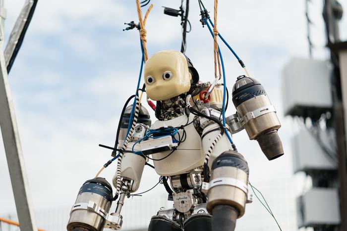 Institute of Informatics and Telematics humanoid robot suspended with restraints