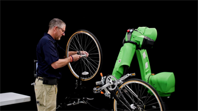Cobots can handle a wide variety of workpieces of varying complexity. Here, one of FANUC's CRX cobots is shown assisting a human during an assembly task. Credit: FANUC