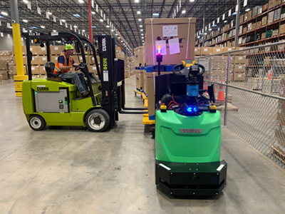 Pivotal software allows companies to assign the most effective mix of humans and automation in a facility. Here, a human forklift driver works with an automated counterpart on a goods transportation task. Credit: Vecna Robotics  