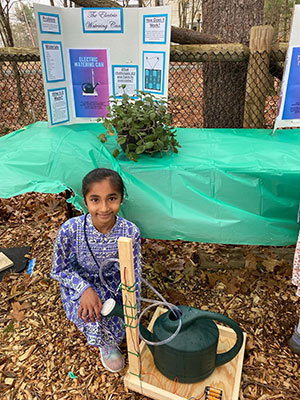 Anaina Cheedella with the motorized pump she developed with help from her teacher to water plants