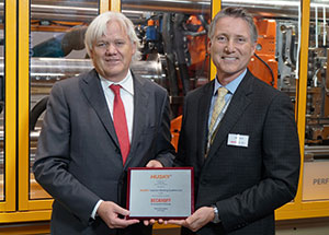 John Galt (right), president and CEO of Husky Injection Molding Systems, presents the “EMEA Supplier of the Year” award to Hans Beckhoff, managing director and owner of Beckhoff Automation, in October 2019 at the K show in Düsseldorf, Germany.