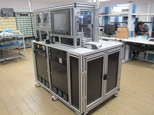 Isometric view of the Final Vision Station (overall system). HMI can be seen on the top right corner. The “pass” conveyor (white, plastic) can also be seen from this view. The small door below the HMI contains (inside) the reject bin.