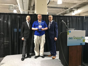 Douglas Davidson receives the gold level award from Alan Bergstein and John Lewis of Vision Systems Design