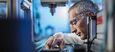 Man aligning plate on a microscope