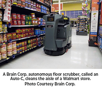 A Brain Corp. autonomous floor scrubber, called an Auto-C, cleans the aisle of a Walmart store
