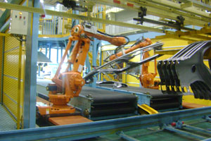 robotic arms lift the part onto the assembly line