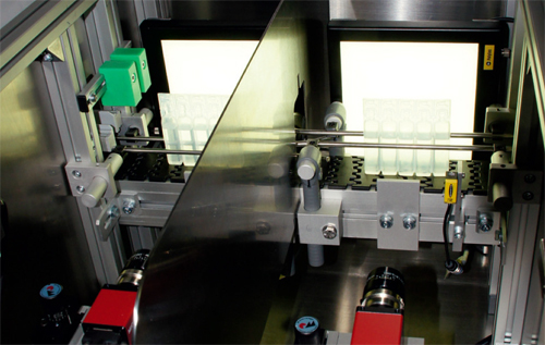 As ampoules enter the system, an HMI screen displays the machine vision software interface and results of the inspection.