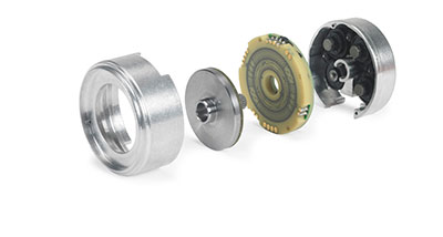 Exploded view of an inductive encoder shows lithographically patterned coils (second from right) and conductive disc (third from right). (Courtesy of Heidenhain)