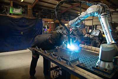 A welder at MT Solar in Montana uses Vectis Automation’s Cobot Welding Tool, powered by Universal Robots