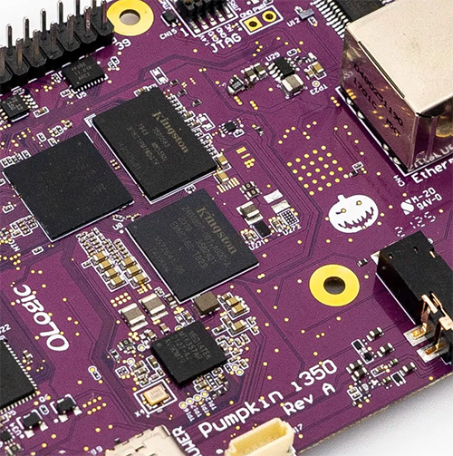 Zoomed in image of the Pumpkin i350, a purple computer board/EVK. There is our OLogic logo and a small white pumpkin logo on the board.