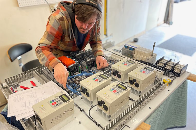 An engineer wiring a robotic solution