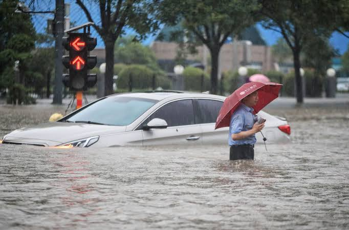 man with umbrella in flood