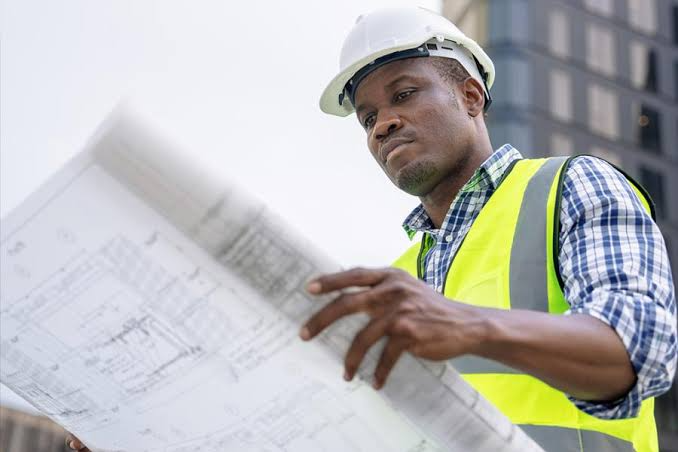 construction worker looking at blueprint