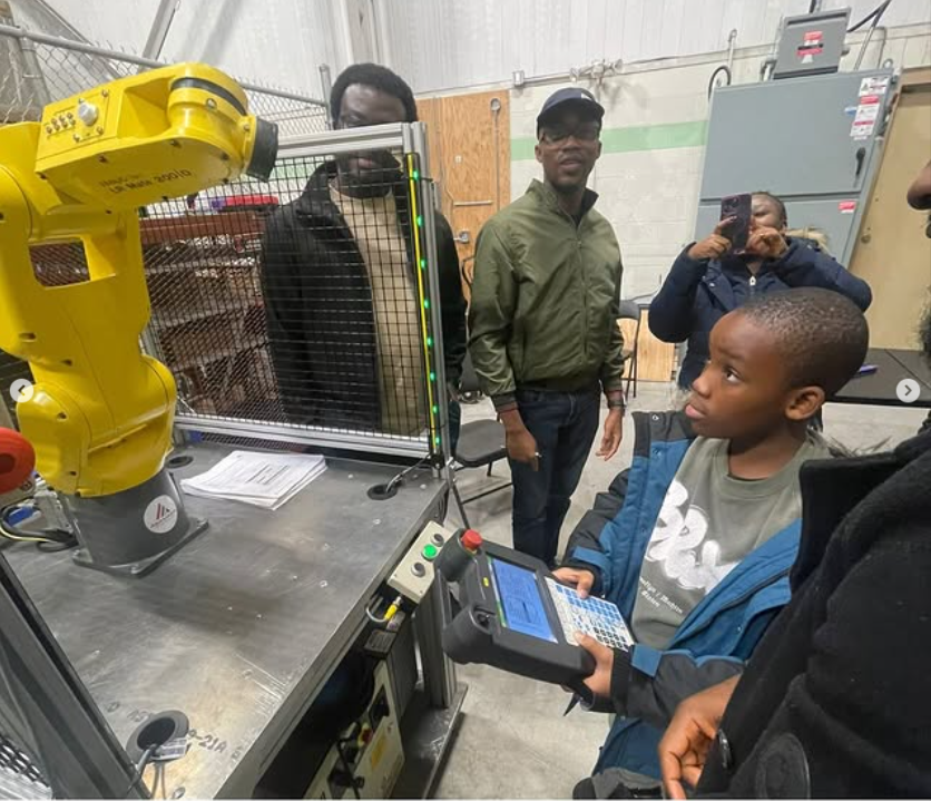 child using teach pendant with robot