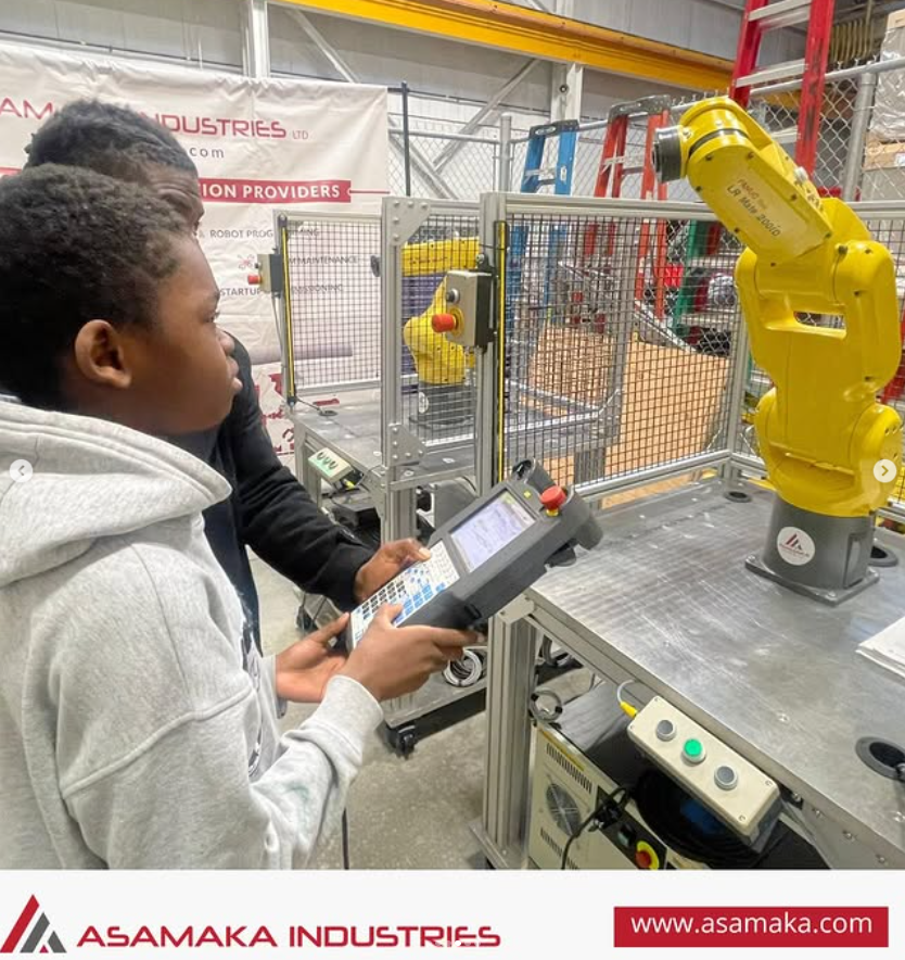 child using teach pendant with robot