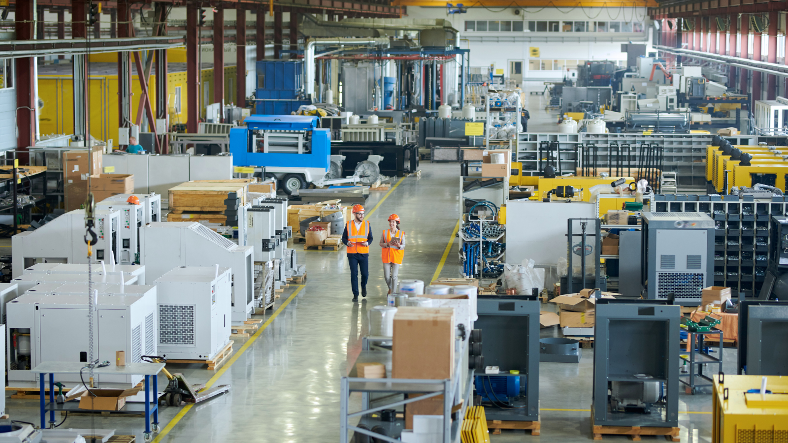 manufacturing warehouse with two workers walking