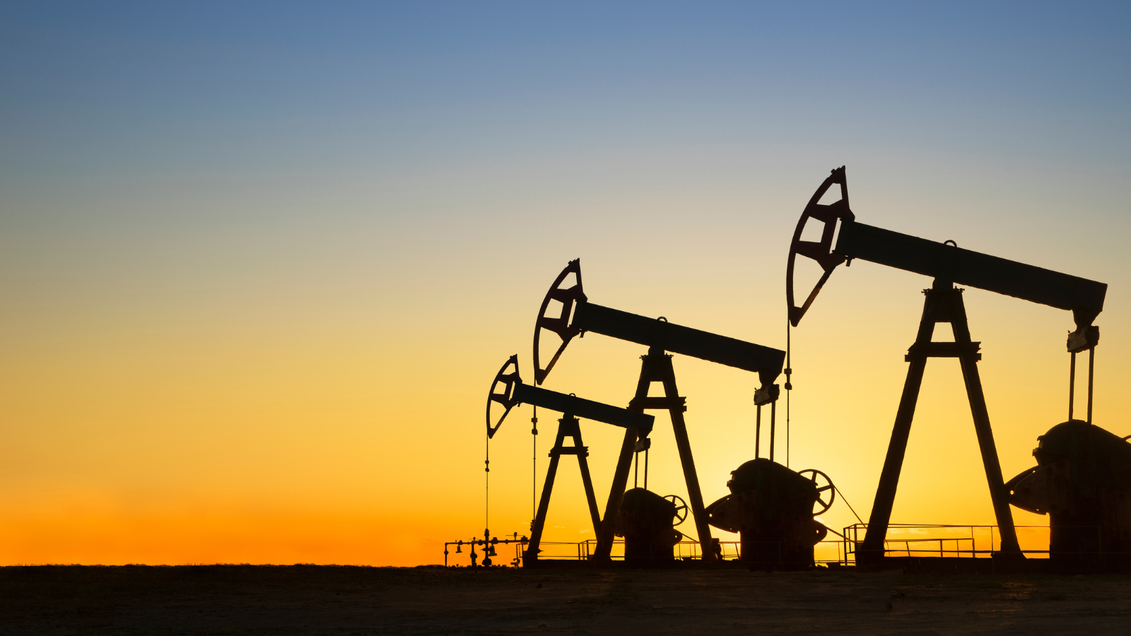 oil rigs at sunset
