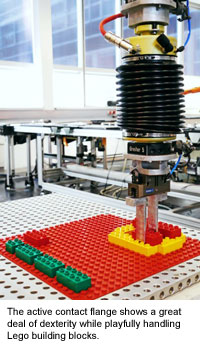 The active contact flange shows a great deal of dexterity while playfully handling Lego building blocks.