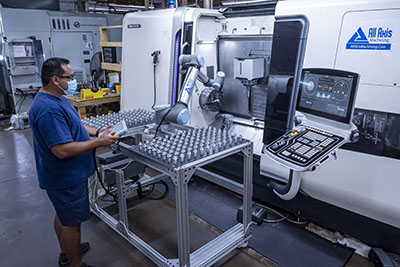 Machine tending collaborative robot helps a machine shop stay productive while social distancing workers during potential infectious disease outbreaks. (Courtesy of Universal Robots)