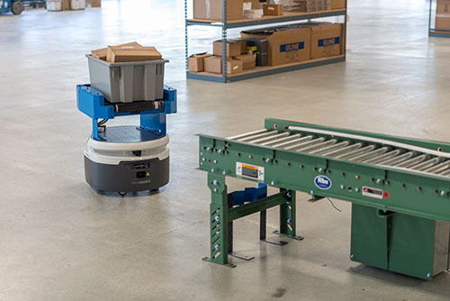 Roller-top autonomous robot communicates via the cloud with third-party devices to facilitate conveyor-to-conveyor material transport. (Courtesy of Fetch Robotics, Inc.)