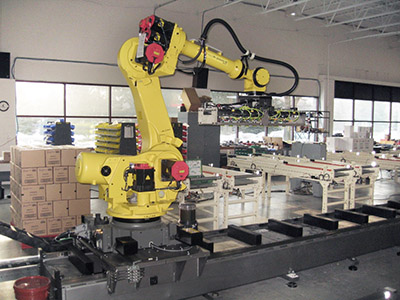 Robotic palletizing system features a track-mounted robot for servicing multiple conveyor lines and promoting social distancing among manual labor. (Courtesy of Midwest Engineered Systems Inc.)