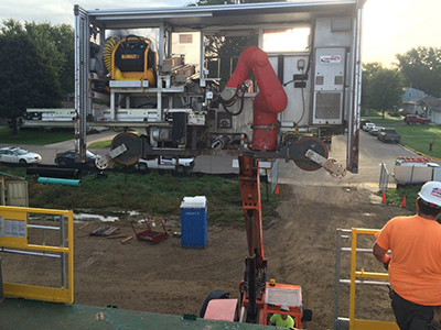 Robotic bricklaying system includes brick manipulation and feeding, mortar system, controls, power and safety all self-contained for easy portability on site. (Courtesy of Construction Robotics)