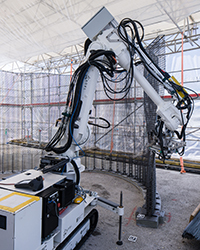 Mobile construction robot used in digital fabrication on a construction site autonomously builds a steel-wire mesh mould in an intricate wave pattern for a concrete wall. (Credit: Roman Keller/NCCR Digital Fabrication)