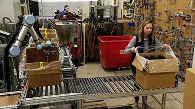 A built-in safety system enables this collaborative robot to work in tandem with employees on the packaging line. (Courtesy Universal Robots)