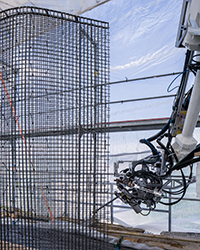 A mobile construction robot equipped with sophisticated end-of-arm tooling autonomously bends, cuts and spot welds a steel-wire concrete mould. (Credit: Roman Keller/NCCR Digital Fabrication)