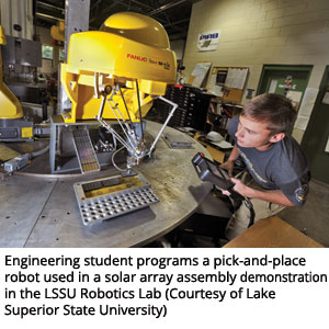 Engineering student programs a pick-and-place robot used in a solar array assembly demonstration in the LSSU Robotics Lab (Courtesy of Lake Superior State University)