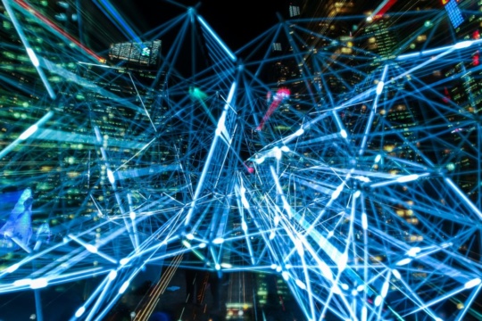 An image of points of light connecting buildings, devices,and people like in Electronic data interchange (EDI)