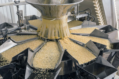 A photograph of machinery in an automated food factory that produces pasta