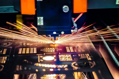 A photo of a CNC machine cutting metal shapes and forms.