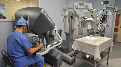 A photo of a surgeon and collaborative robot practicing in an operating room.