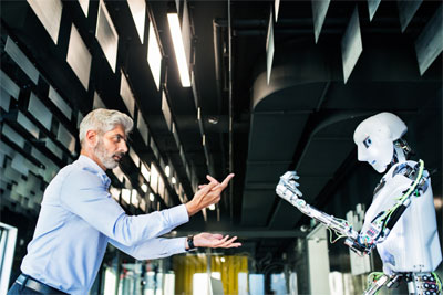 A photograph of an executive or scientist commanding a humanoid robot