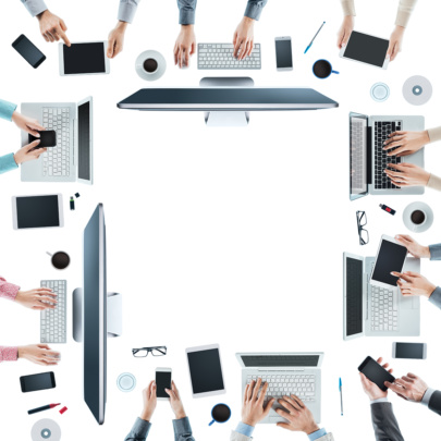 An image of a table of office workers using computers, tablets, and mobile devices around a table.