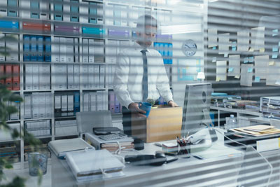 A photo of a Fired office worker holding a box