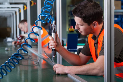 A photograph of factory workers and the production process.