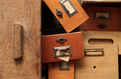 An image of disorganized wooden drawers
