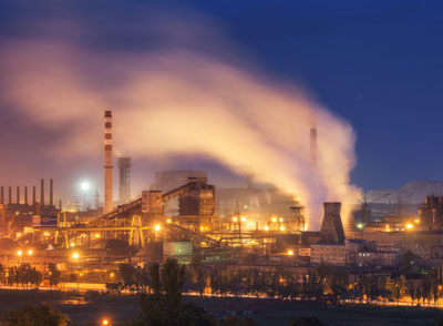 A photo of a metal foundry at night. 