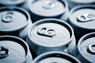 A photo of beverage cans with condensation built up on their surface.