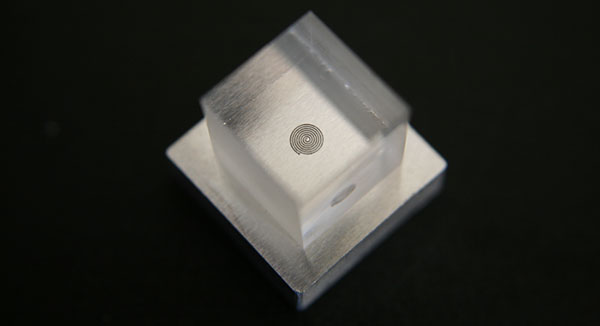 an image of the heriot-watt laser system results, having welded a block of metal and glass together